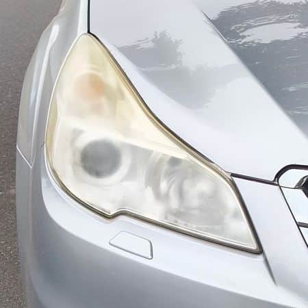 Cloudy and yellowed left-hand headlight on a 2016 Subaru before restoration in Bentleigh East